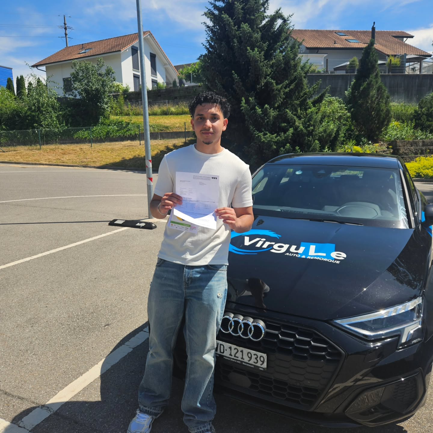 Emir, permis en poche, devant la voiture-école Virgule